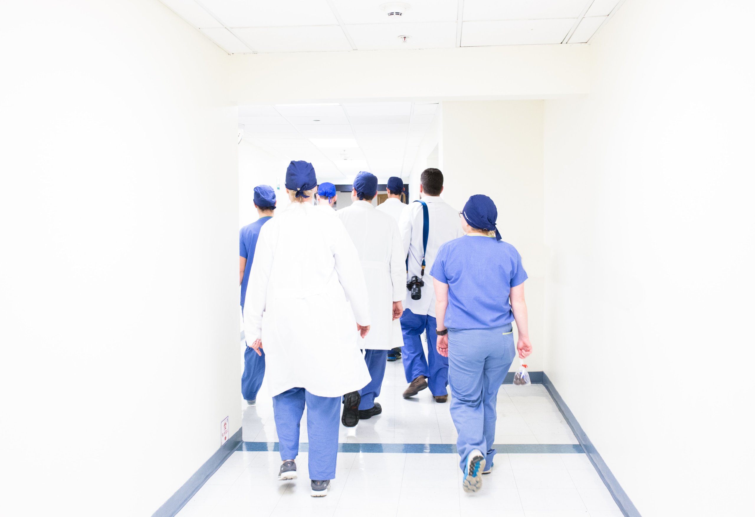 multiple doctors walking away in a hallway